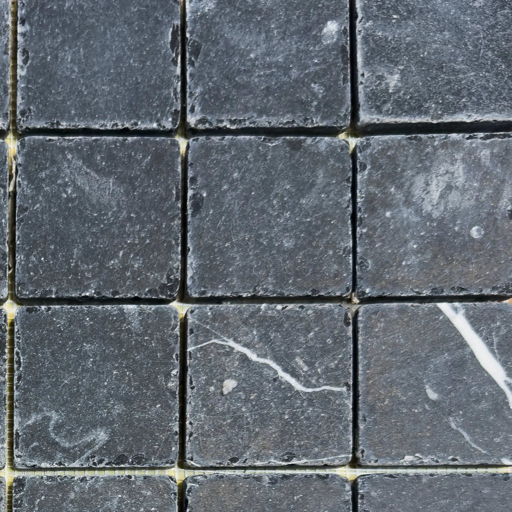 Dark gray square stone tiles of Nero Marquina Marble 2X2 Tumbled for elegant decor