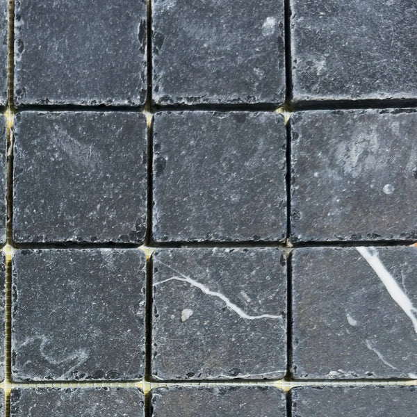 Dark gray square stone tiles of Nero Marquina Marble 2X2 Tumbled for elegant decor