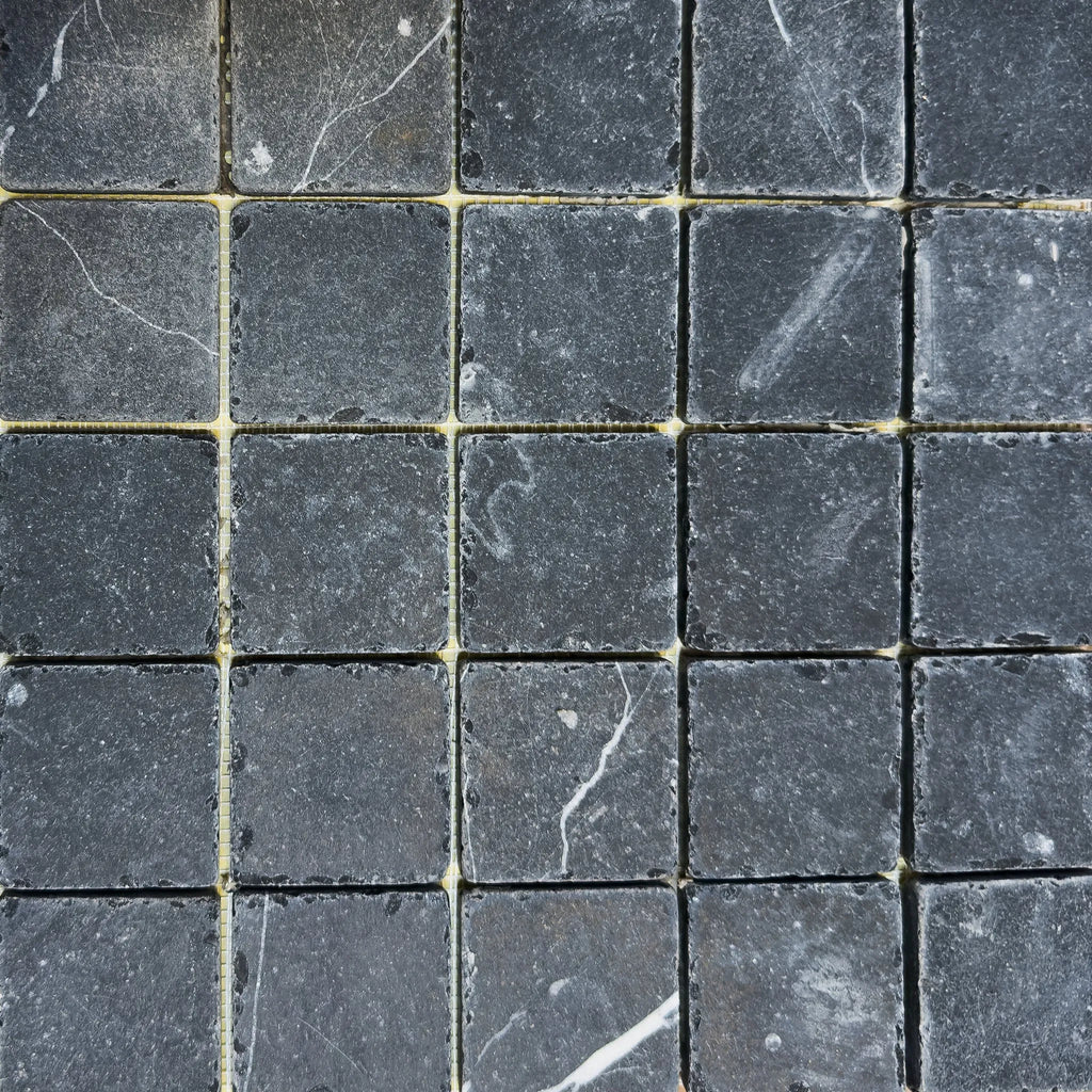 Square gray marble tiles from the Nero Marquina Marble 2X2 Tumbled collection