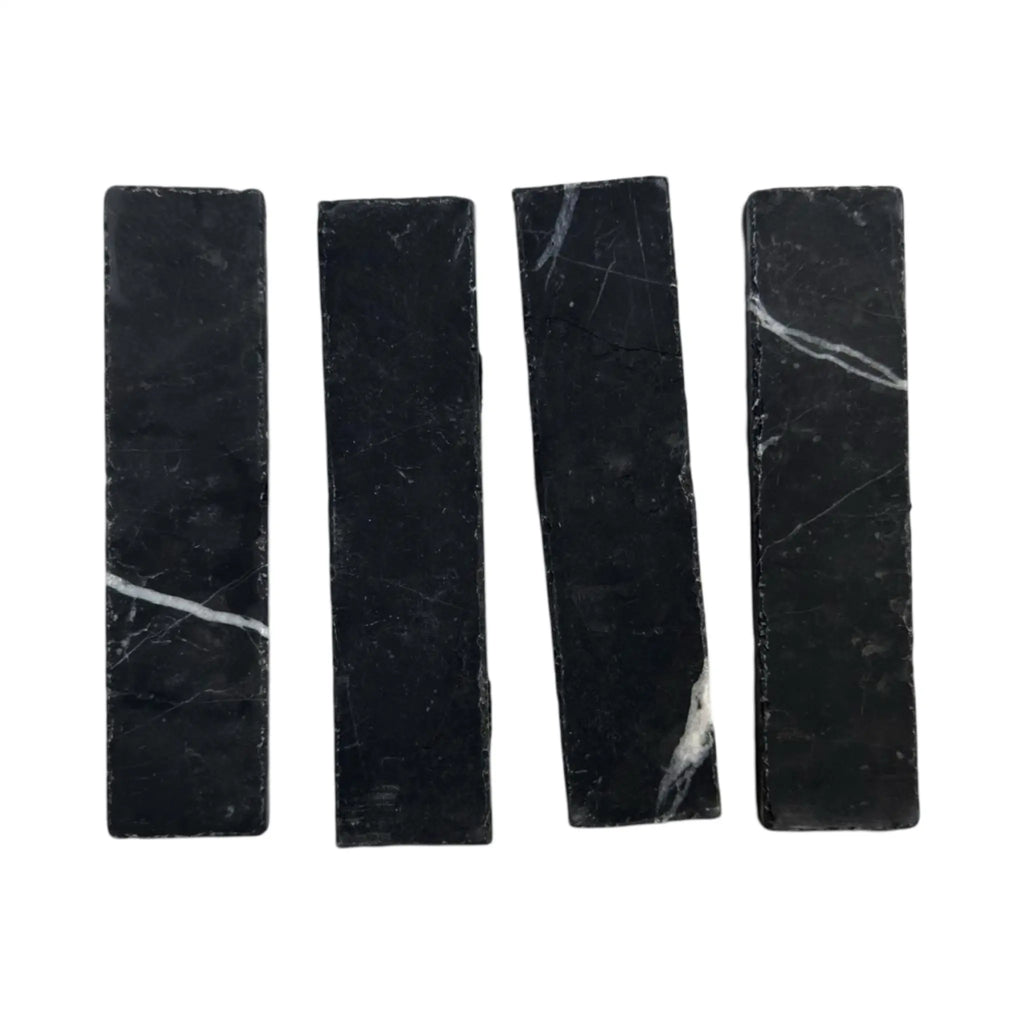 Four black marble rectangles in Nero Marquina Marble 2X8 Mosaic design