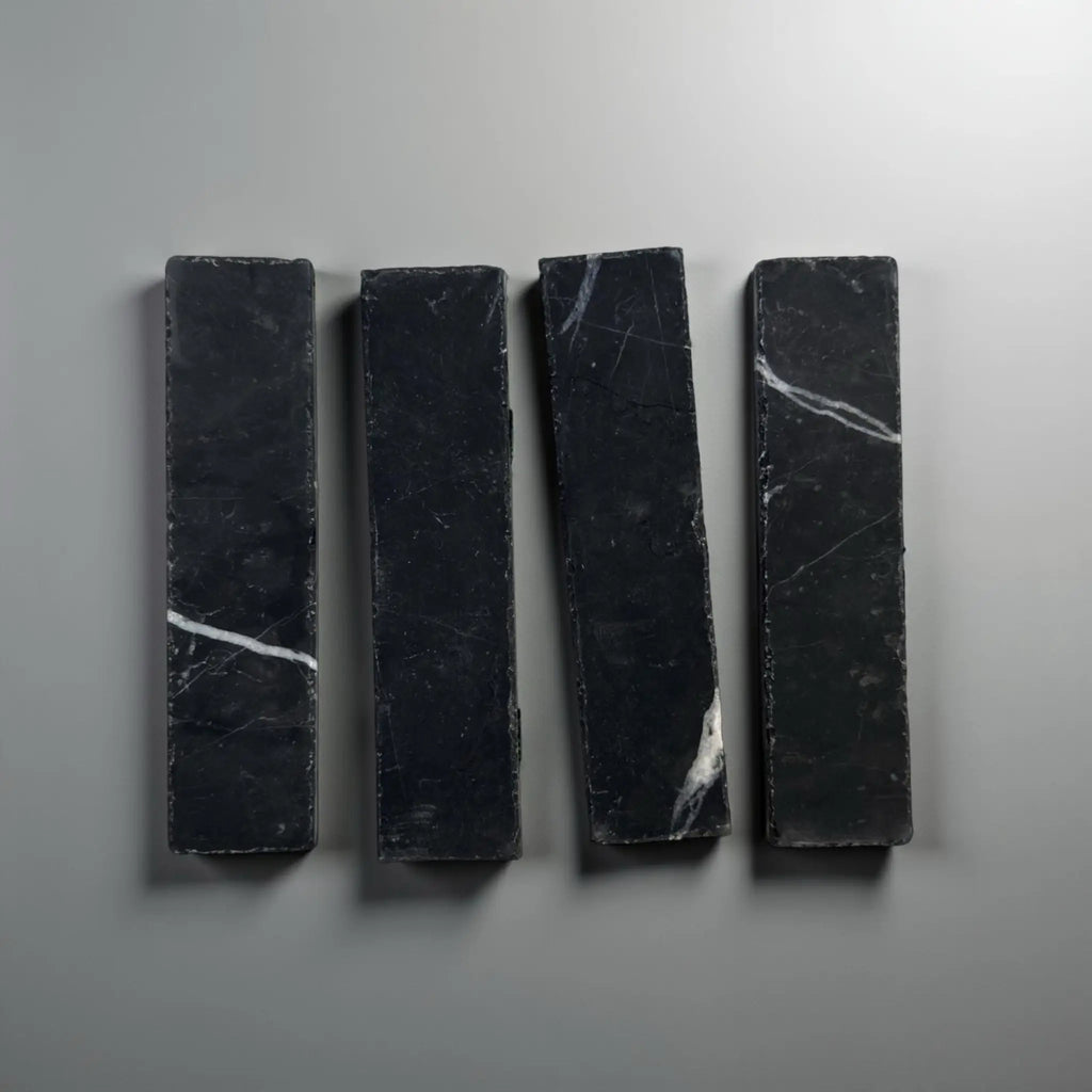 Four black marble rectangles in Nero Marquina Marble 2X8 Mosaic design