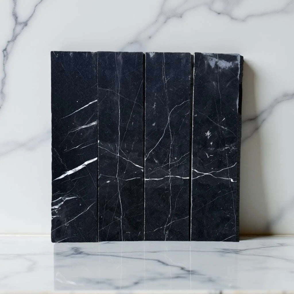 Black marble tiles with white veining in Nero Marquina Marble 3’’ X 12’’ Field Tile