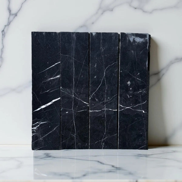 Black marble tiles with white veining in Nero Marquina Marble 3’’ X 12’’ Field Tile