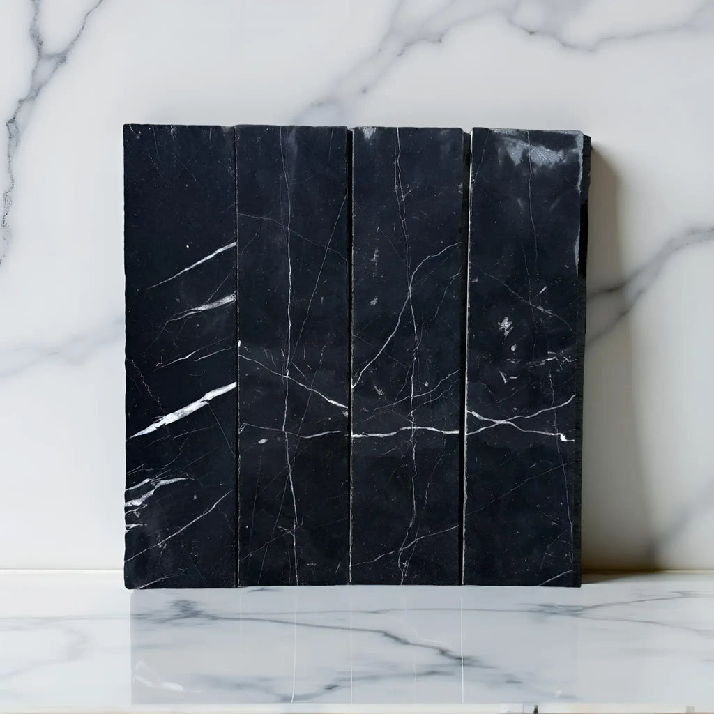 Black marble tiles with white veining in Nero Marquina Marble 3’’ X 12’’ Field Tile