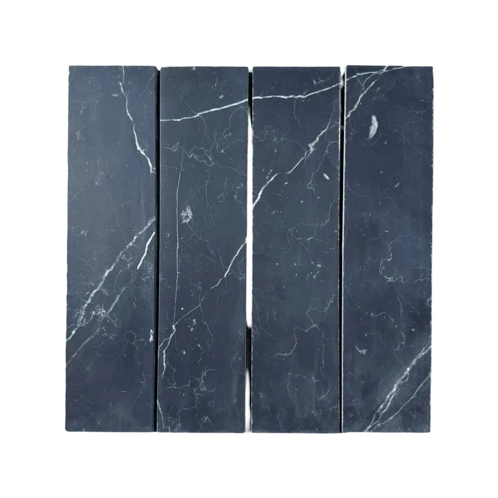 Four Nero Marquina Marble tiles showcasing elegant white veining on a black surface