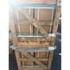 Weathered wooden pallet with diagonal crossbeams and green plastic strapping holding noce brown travertine 12x24 cross-cut filled and honed tiles