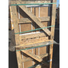 Weathered wooden pallet with green straps securing stacked noce brown travertine 12x24 cross-cut filled and honed panels