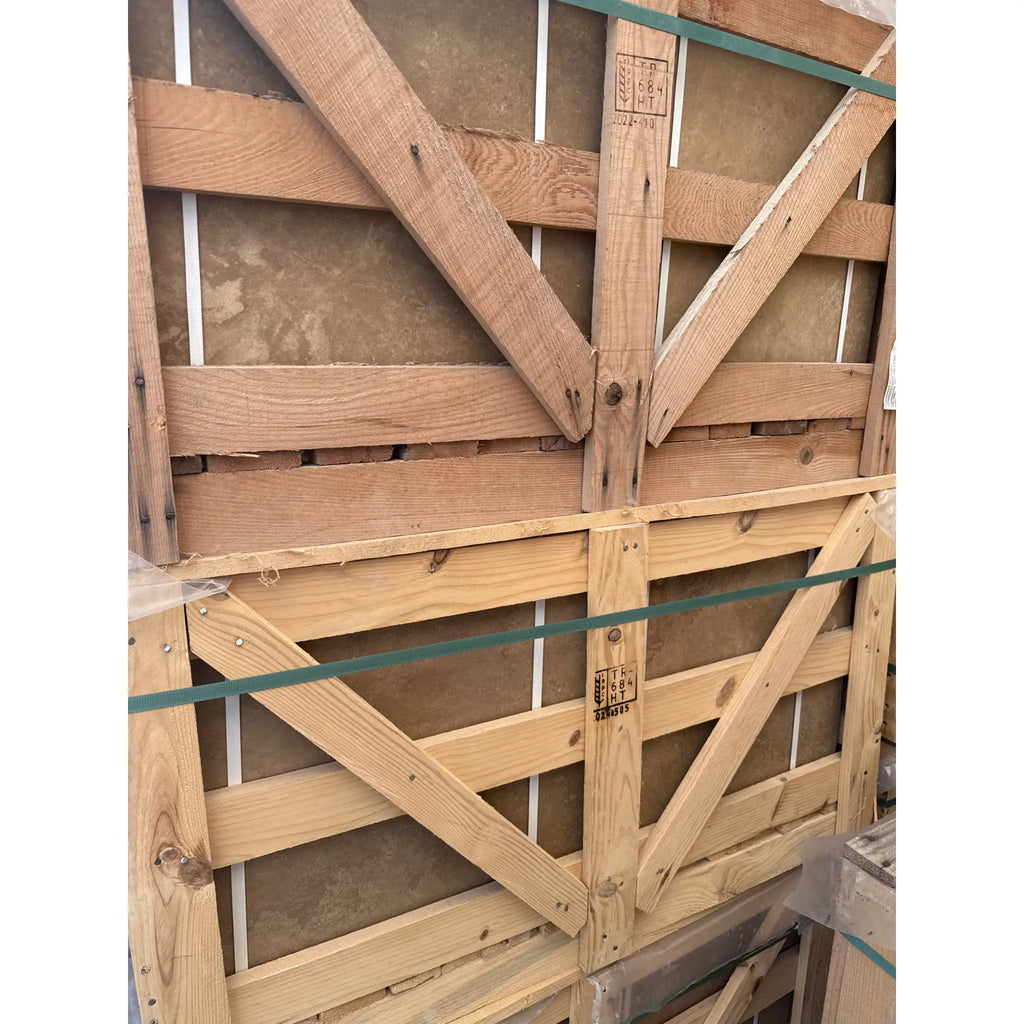 Wooden crates with paintings inside showcasing the Noce Brown Travertine 18x18 tile