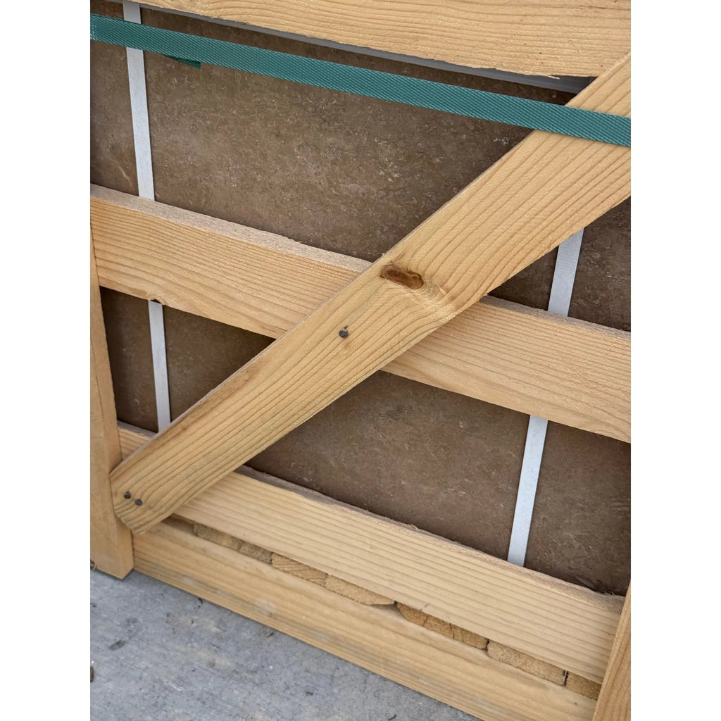 Wooden crate with strapping containing Noce Brown Travertine 18x18 tiles