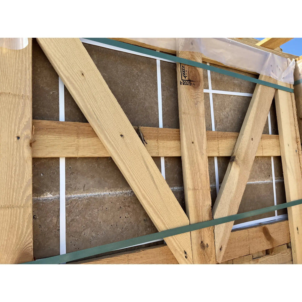 Wooden crate containing Noce Travertine stone slabs in Versailles pattern set