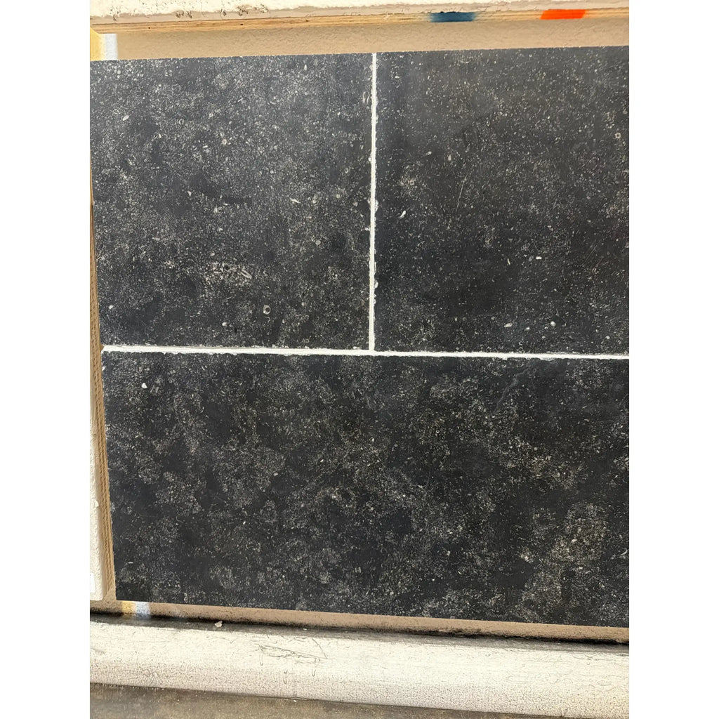 Obsidian Ash 16x24 honed limestone tile with black texture, white veining, matte finish