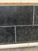 Obsidian Ash 16x24 honed limestone tiles in black textured stone with white grout