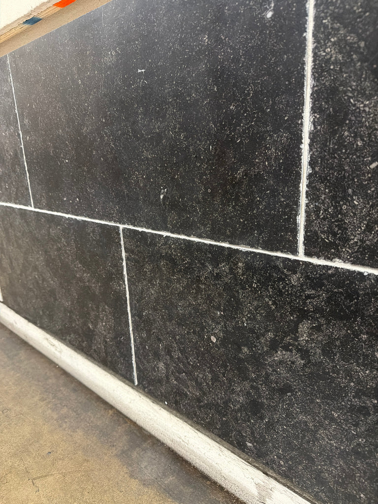 Obsidian Ash 16x24 honed limestone tiles with black texture and white grout