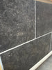 Obsidian Ash 16x24 honed limestone tiles in dark gray speckled texture with white grout