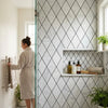 Oriental white asian statuary marble mosaic with white tiles and black diamond grout lines on shower wall