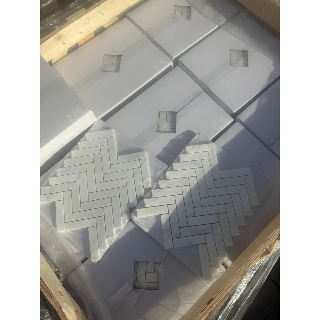 Oriental White 1x4 herringbone marble mosaic tiles in plastic wrap