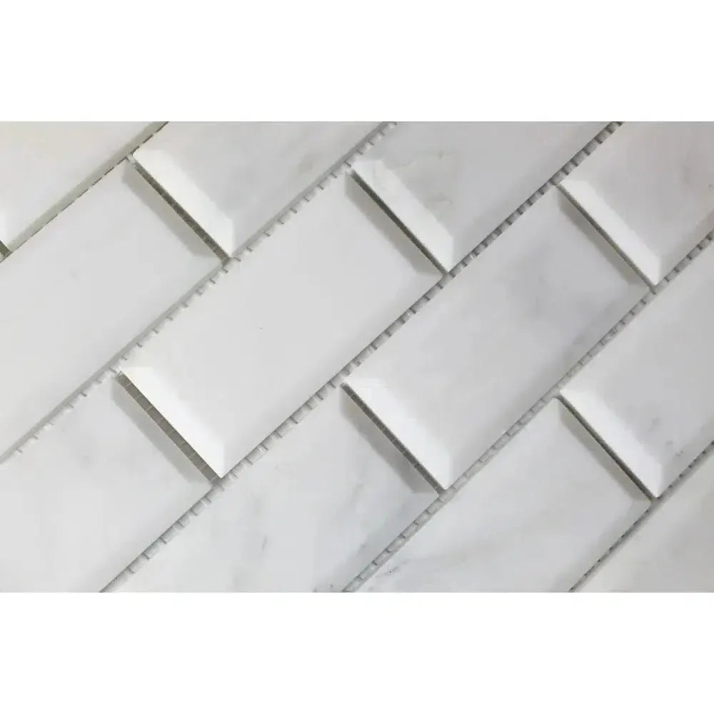 White beveled subway tile in Oriental White Asian Statuary marble mosaic design