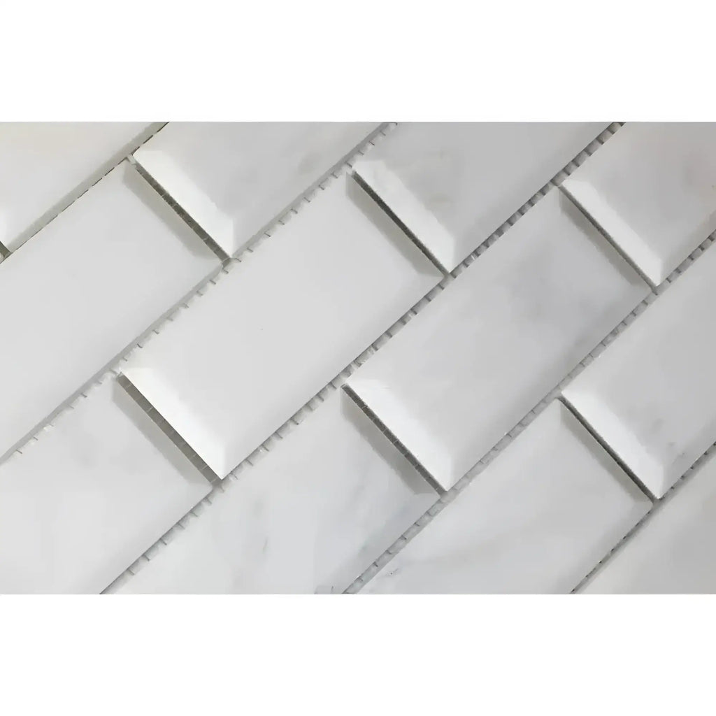 White beveled subway tile in Oriental White Asian Statuary marble mosaic design