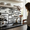 Modern black and white subway tile backsplash featuring sleek geometric pattern in oriental white asian statuary marble mosaic