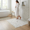 White circular mosaic bath mat in oriental white asian statuary bubbles marble with a subtle textured surface
