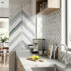 Silver espresso machine with black accents and modern design alongside Oriental White Asian Statuary Chevron marble mosaic