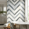 The wall features oriental white asian statuary chevron large marble mosaic polished tiles in white and gray