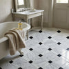 White marble mosaic floor tiles with black diamond accents in oriental white asian statuary lattice polished finish