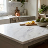 White marble kitchen island countertop with subtle gray veining in oriental white asian statuary marble 12x12 polished