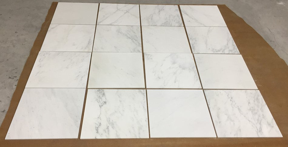 White marble tile floor mat with gray veining and grout lines from Oriental White Asian Statuary Marble 12X12