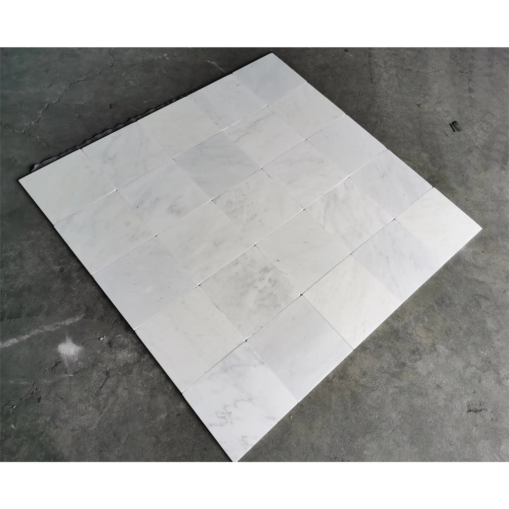 White marble tile arrangement of Oriental White Asian Statuary Marble 12X12 Tumbled