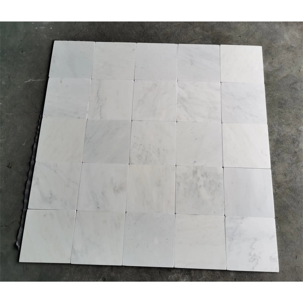 White marble tile arrangement of Oriental White Asian Statuary Marble 12X12 Tumbled