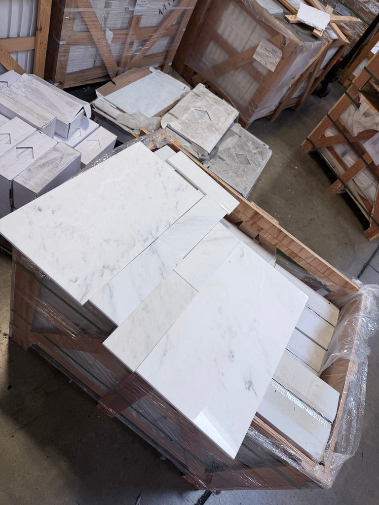 Oriental White marble vanity panels, 12x24 polished, stacked on pallets