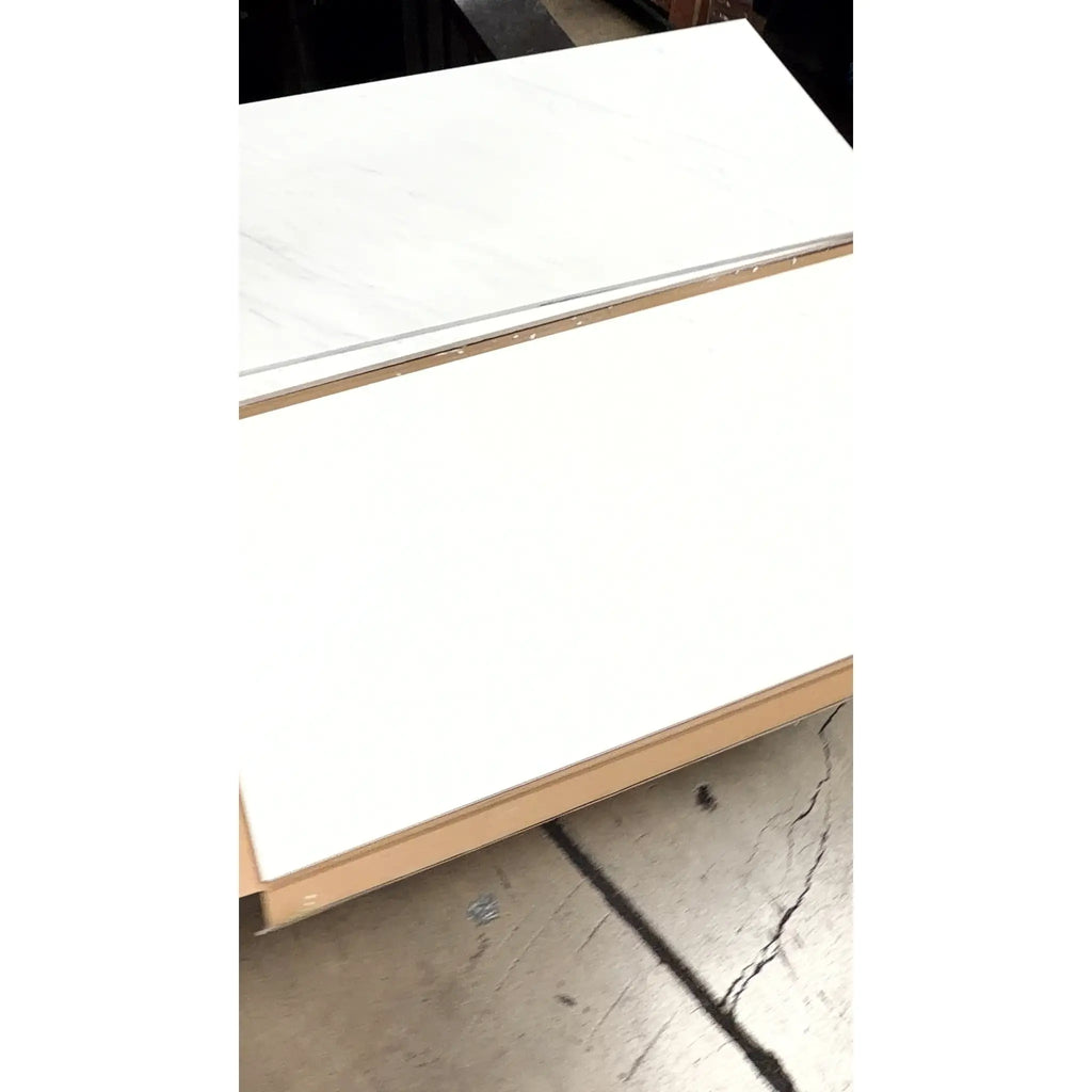 White marble effect countertop panel with subtle gray veining framed in light wood oriental white asian statuary marble