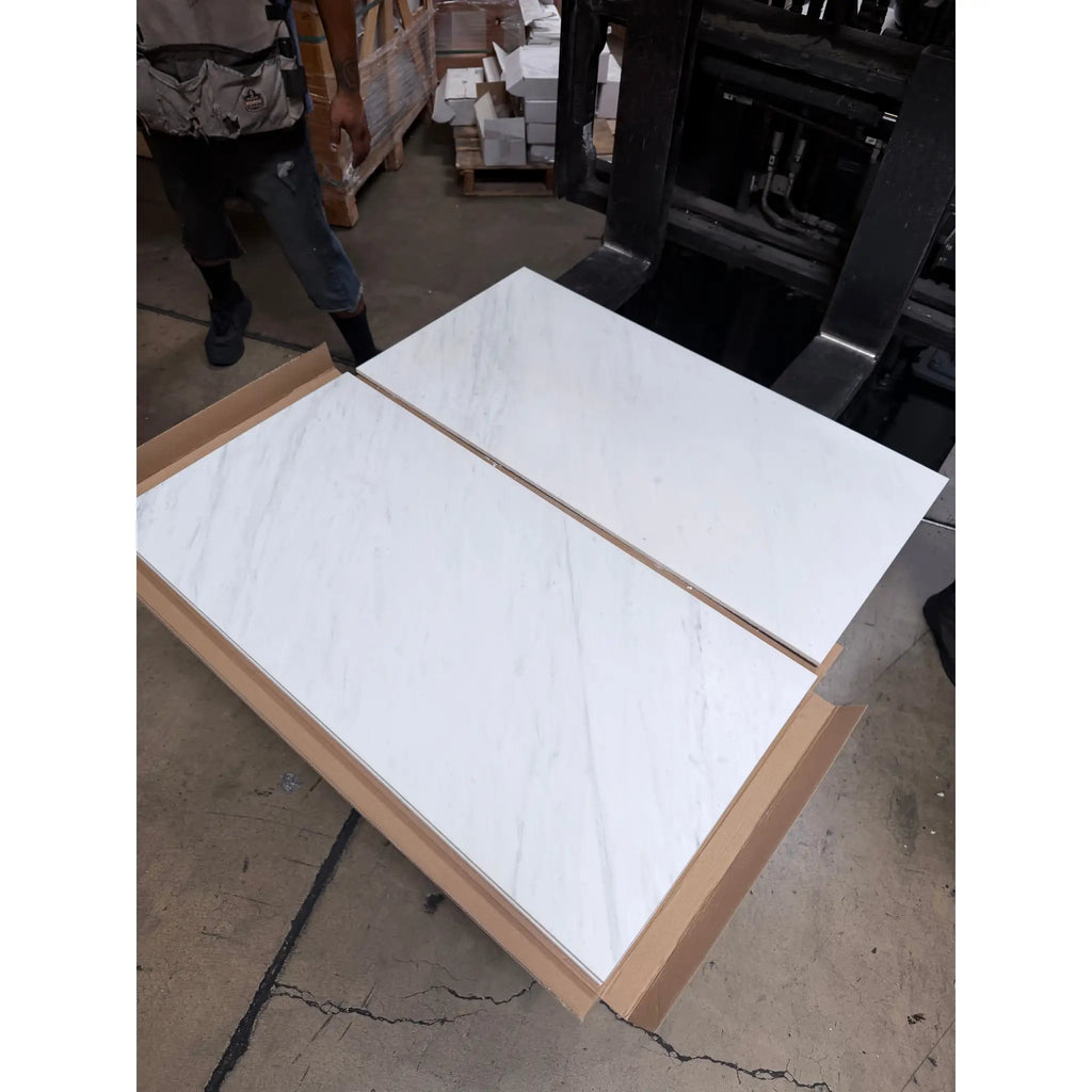 White marble-effect kitchen cabinet doors with oriental white asian statuary marble and light wood trim in minimalist design