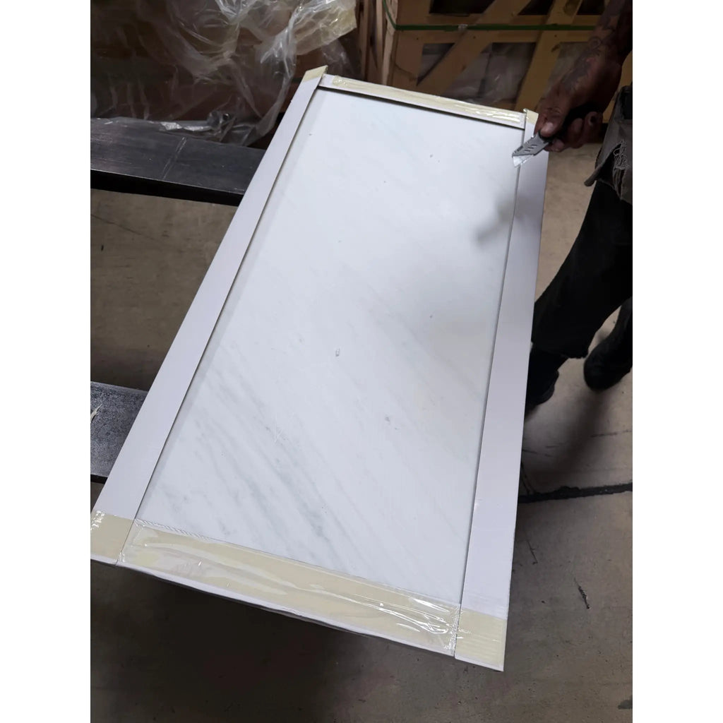 White marble-patterned Oriental White Asian Statuary marble cabinet panel with light wood frame and sealed edges