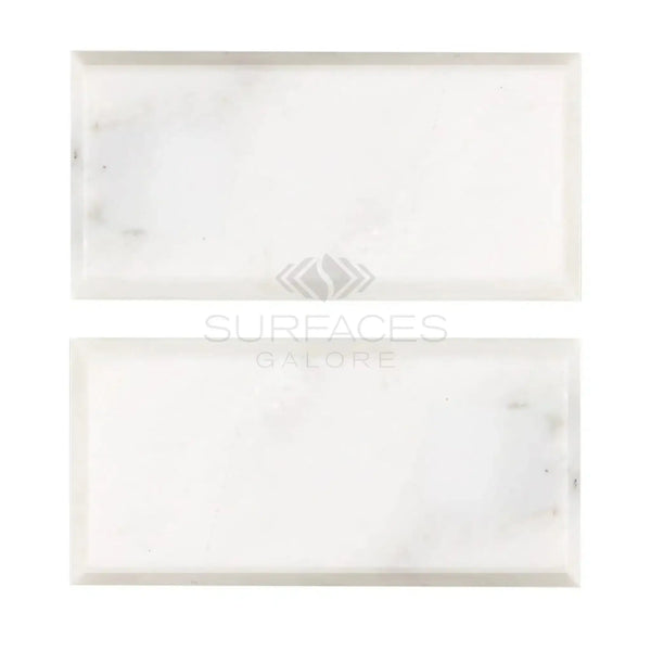 Two white marble tiles of Oriental White Asian Statuary Marble 3X6 Deep-Beveled