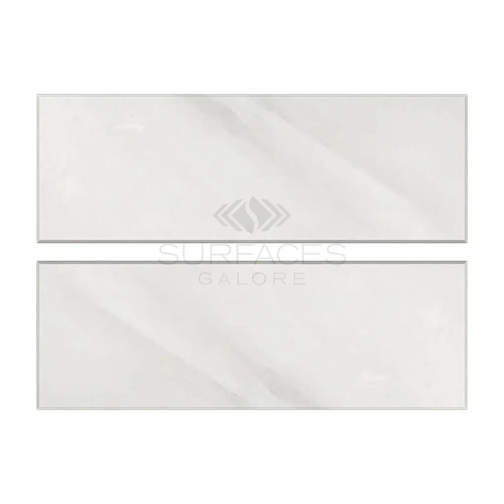 Two light-colored rectangular tiles of Oriental White Asian Statuary Marble 4X12