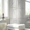 Stack of crisp white towels neatly folded on a bathroom counter with oriental white asian statuary marble 4x4 polished tiles