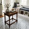 Dark wood console table with turned legs and woven basket base paired with oriental white asian statuary stanza mosaic marble