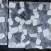 Pebble-style mosaic tiles in Dolomite, Bardiglio, and Palissandro Tumbled Stone Sheet