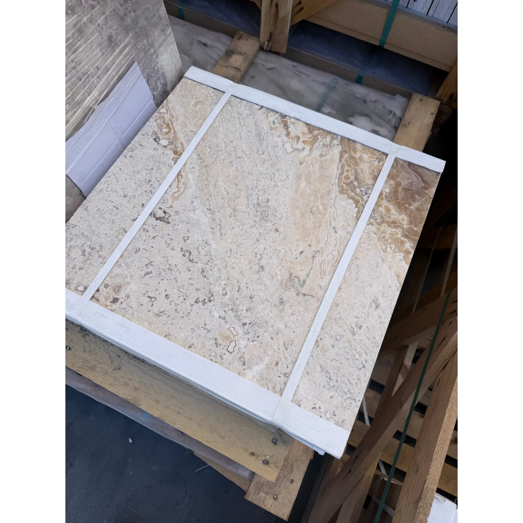 Beige Philadelphia travertine 18x18 marble tile with natural veining and a white border, filled and honed finish