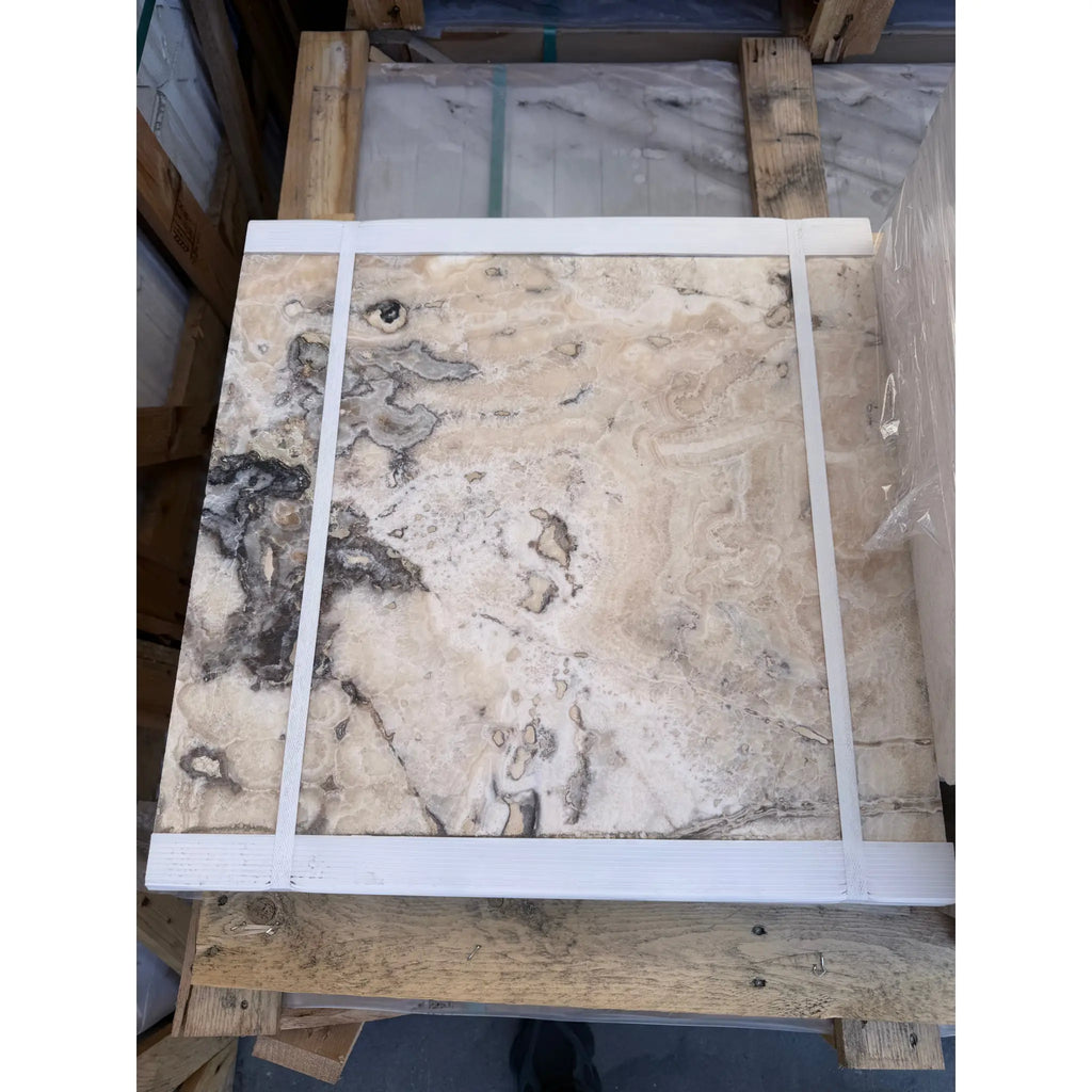 A square slab of Philadelphia Travertine natural stone with creamy beige base and dark gray veining 18x18 filled and honed