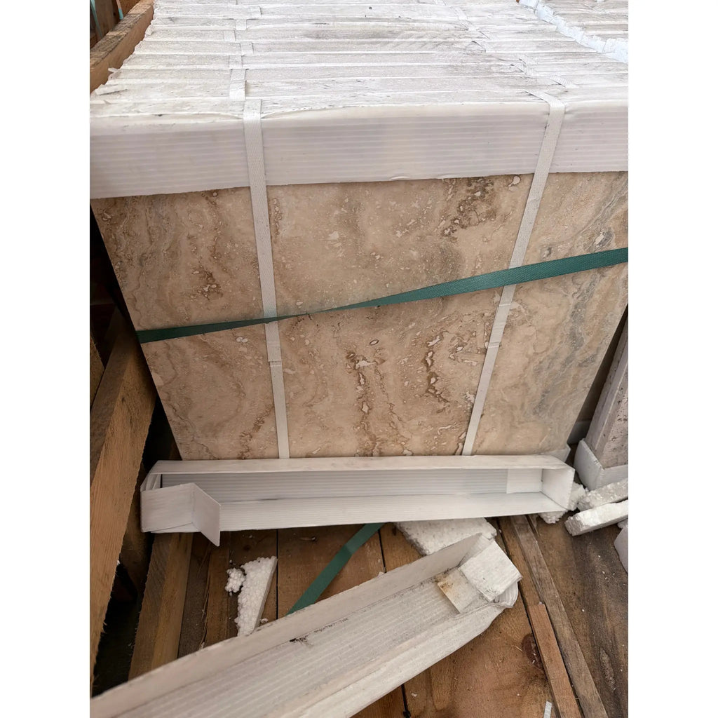 Philadelphia Travertine 18x18 filled and honed beige marble tiles stacked with natural veining, secured by white and green straps