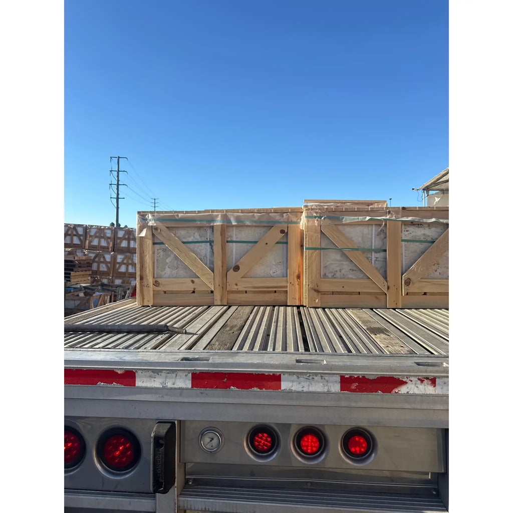Wooden crates filled with Philadelphia Travertine 18x18 tiles secured on flatbed trailer