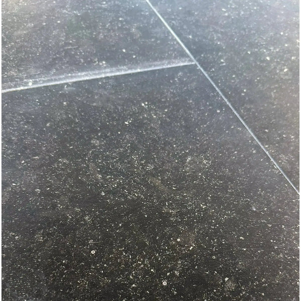 Black speckled floor tiles in Pierre Bleue 12X24 Brushed Marble design