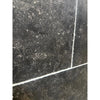 Pietra Notte Marble 16x24 tile with black surface, white grout, speckled texture