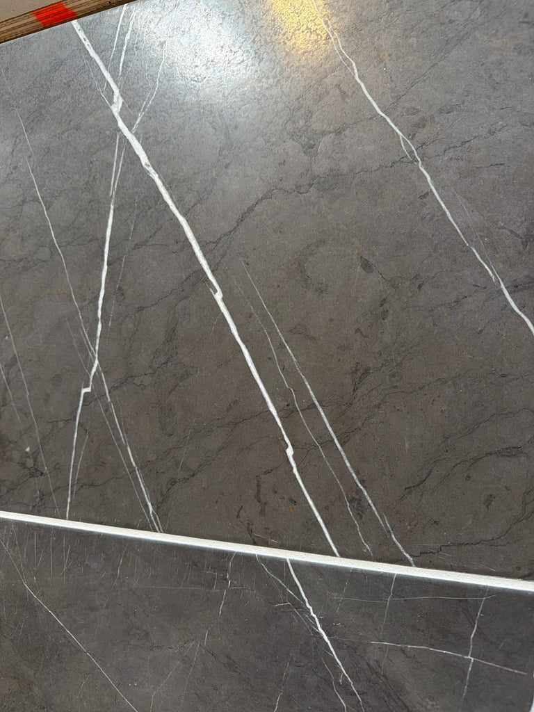 Dark gray Pietra Notte marble tile with elegant white veining, 16x24