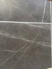 Dark gray Pietra Notte marble tile with elegant white veining, 16x24 size