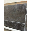 Dark gray Pietra Notte Marble 16x24 tile with mottled texture and white grout