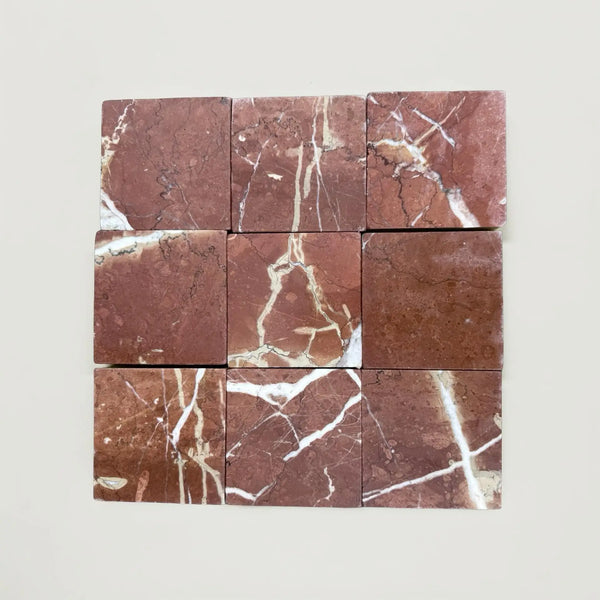Nine reddish-brown Rojo Alicante 4X4 Tumbled marble tiles with white veining
